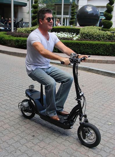 Simon Cowell, riding scooter, Boston, June 28, 2012.