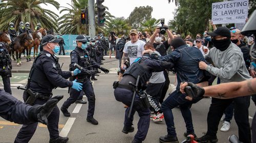 Protesters and members of Victoria Police clash on October 23, 2020 in Melbourne, Australia