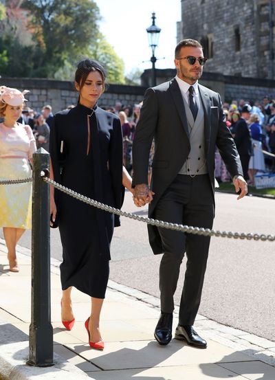 Fashion designer Victoria Beckham opting for all-navy with soccer star husband <strong>David Beckham photographed walking to the Royal wedding</strong>