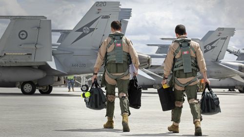 F/A-18F Super Hornet aircrew head to their aircraft in preparation for departure to the Middle East. (ADF)