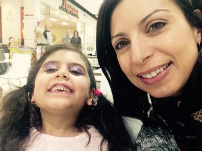 Jo Abi with her daughter wearing purple eyeshadow smiling