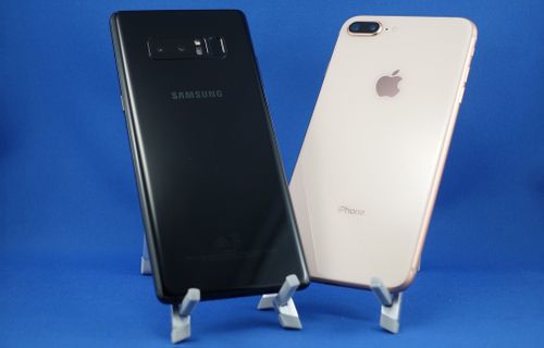 The Samsung is taller and thicker, but the Apple model is slightly heavier.