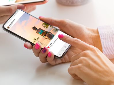 Two women using their mobile phones together