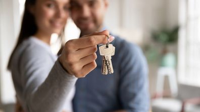 House keys new home owner first home buy couple holding keys