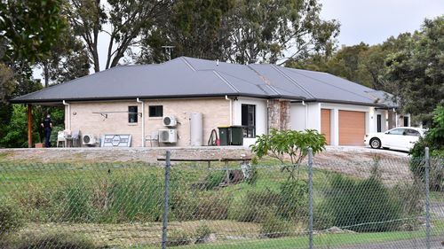 Police are seen at a house on Muller Road in the Brisbane suburb of Taigum