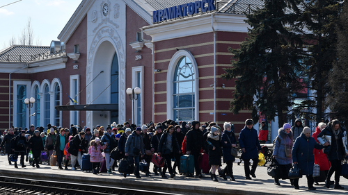 People walk to catch the last train and leave Kramatorsk for western Ukraine at the railway station in Kramatorsk, Ukraine, Sunday, March 13, 2022. (AP Photo/Andriy Andriyenko)
