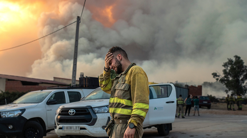 A firefighter cries near a wildfire in the Losacio area in north western Spain on Sunday July 17, 2022. Firefighters battled wildfires raging out of control in Spain and France as Europe wilted under an unusually extreme heat wave.
