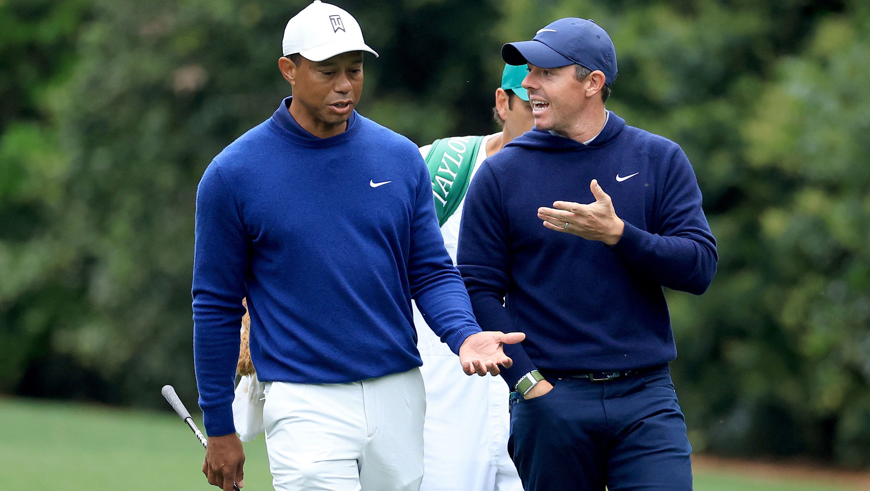 Rory McIlroy and Tiger Woods of the United States walk together on the 11th hole during a practice round prior to the 2023 Masters Tournament at Augusta National. 