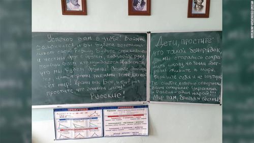 A note that was found on a blackboard in a school in Katyuzhanka after Russian troops left the area. One phrase says: "Ukraine and Russia are one people!!!"