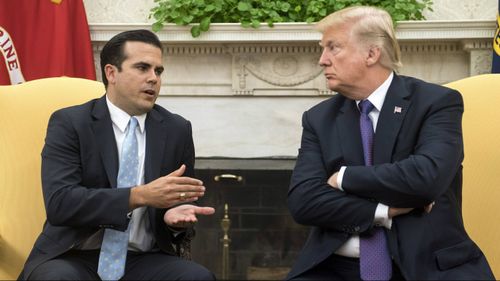 President Donald Trump speaks with Puerto Rico governor Ricardo Rossello in October. Mr Trump was criticised for what many saw as an inadequate response to the devastation wrought on Puerto Rico by Hurricane Maria.