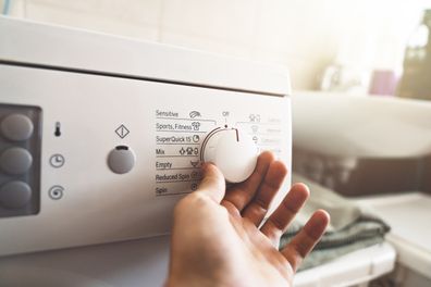 Man preparing the washing machine to start working