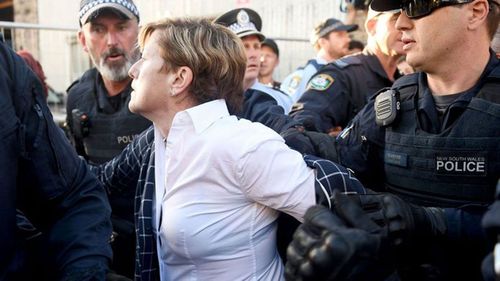 Christine Forster's jacket was ripped off in the ensuing chaos. (AAP)