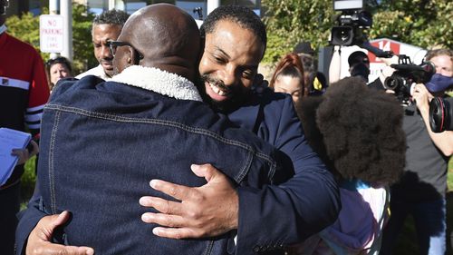 Juwan Deering,(right), was greeted by his brother Antawan Deering, (back to camera), 48, of Detroit after he was released from custody after all charges in a 2000 arson fire were dropped. 
