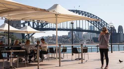 Many owners say it won't be sustainable for them to reopen if they are forced to close for a fortnight whenever a case is linked to the venue. Diners eat at the Portobello Caffe at Circular Quay on June 01, 2020 in Sydney, Australia. 