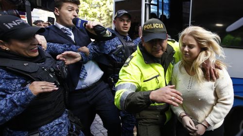 Cassie Sainsbury was escorted by police into a Bogota court this morning. (AAP)