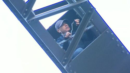 CCTV cameras captured Wayne Cook riding a push bike along the Harbour Bridge before abandoning it and scaling a security fence. 