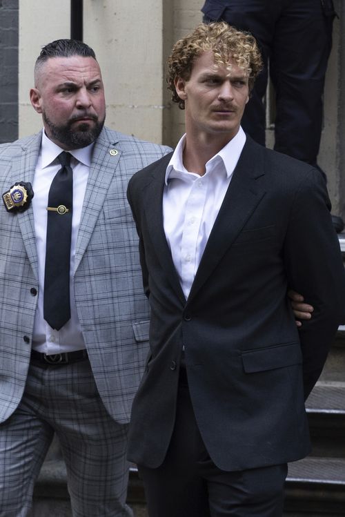 Daniel Penny, center, is walked by New York Police Department detectives detectives out of the 5th Precinct on Friday, May. 12, 2023 in New York.