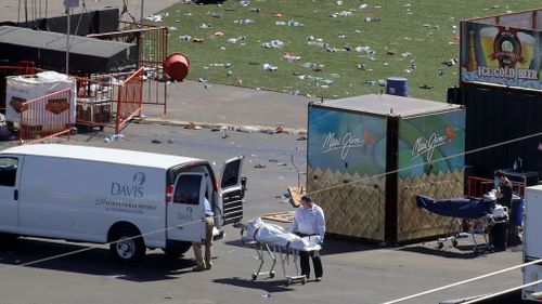 Investigators load a truck with bodies from the scene of the mass shooting. (AP)