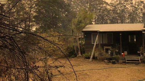 Paul Sekfy's home, which he joked was saved by the 'heroes and milk sneaks' of Urunga RFS.