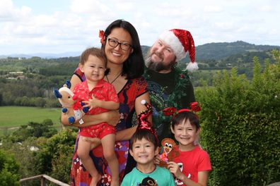 Sarah Yip poses with her family, including her three sons.