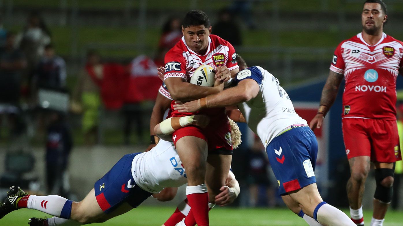 Jason Taumalolo captain of Tonga is tackled (C) during the International Rugby League Test match between the Great Britain Lions and Mate Ma&#x27;a Tonga 