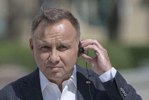 Polish President Andrzej Duda listens through an earpiece to Ukrainian President Volodymyr Zelenskyy during a joint news conference in Kyiv, Ukraine, Tuesday, Aug. 23, 2022.