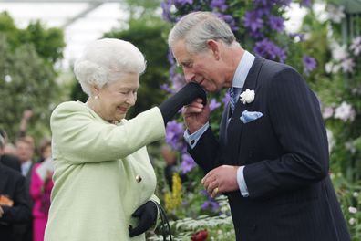 LONDON - MAY 18:  Queen Elizabeth II presents Prince Charles, Prince of Wales with the Royal Horticultural Society's Victoria Medal of Honour during a visit to the Chelsea Flower Show on May 18, 2009 in London. The Victoria Medal of Honour is the highest accolade that the Royal Horticultural Society can bestow. (Photo by Sang Tan/WPA Pool/Getty Images)