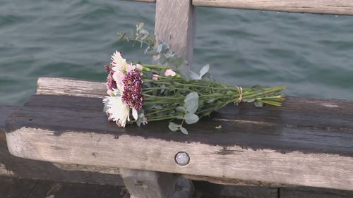 Flowers have been laid at the site by both friends and strangers, as a police investigation continues.