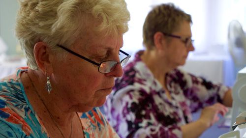 Volunteers hard at work sewing. (Ehsan Knopf/9NEWS)