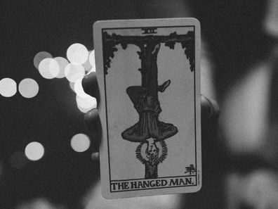 A stock photo of the hanged man tarot card.