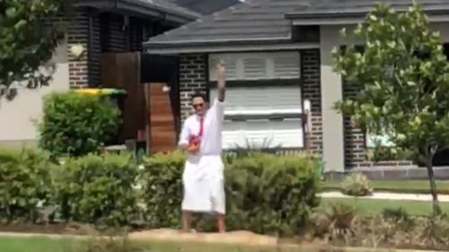 In the video, the man is seen travelling along the street and waving to residents as they thank him for the performance. (Facebook)