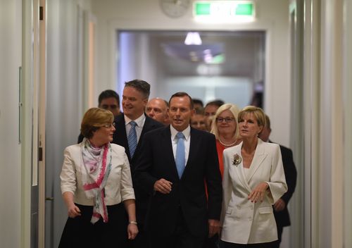 Prime Minister Tony Abbott and fellow MPs arrive for a special Liberal party room meeting at Parliament House in Canberra.