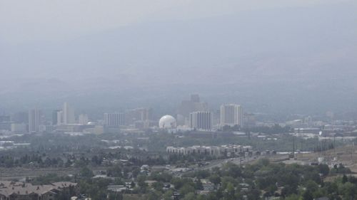 Smoke from wildfires in California covered downtown Reno, Nevada in the United States, which has contributed to air pollution. 