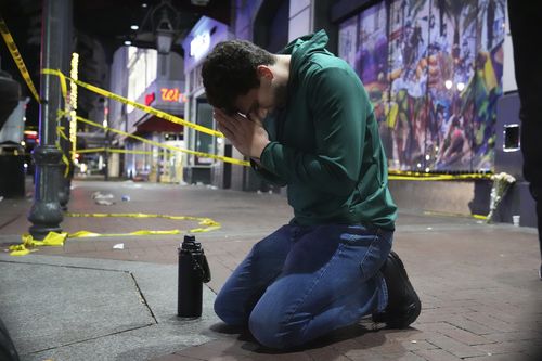 Matthias Hauswirth of New Orleans prays on the street near the scene where a vehicle drove into a crowd on New Orleans' Canal and Bourbon streets