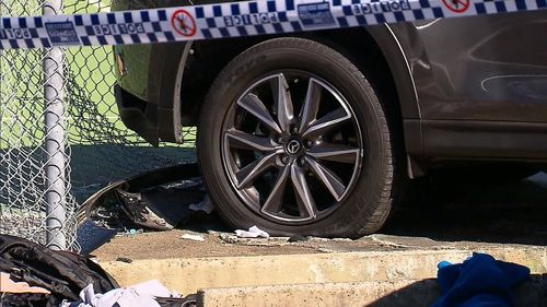 A woman was pinned against the fence after the car hit her. Image: 9News