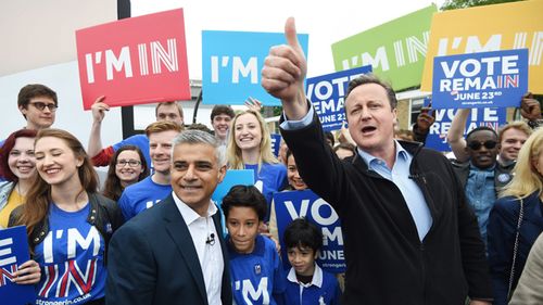 British Prime Minister David Cameron (R) and Mayor of London Sadiq Khan (L) greet supporters during the launch of the battle bus for the 'Remain In' campaign