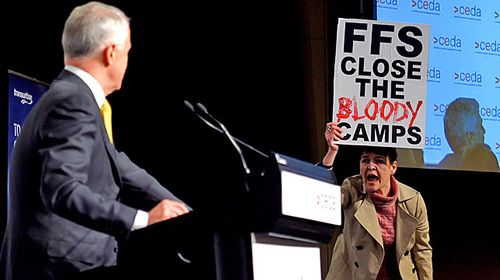 Agnes Prest from the Whistleblowers Activists and Citizens Alliance interrupts Prime Minister Malcolm Turnbull first major economic address since the Federal election at a CEDA luncheon in Melbourne. (AAP)
