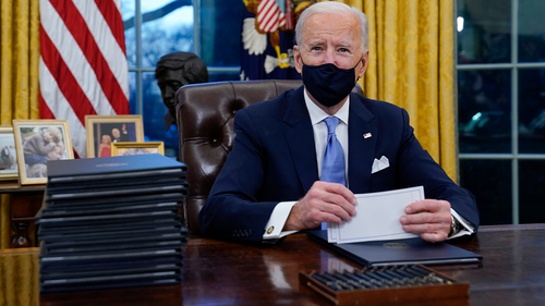 President Joe Biden pauses as he signs his first executive orders in the Oval Office of the White House on Wednesday, Jan.20, 2021, in Washington.  (AP Photo / Evan Vucci)