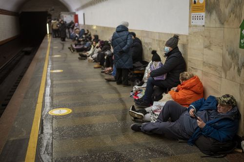 People lie in the Kyiv subway, using it as a bomb shelter in Kyiv, Ukraine, Thursday, Feb. 24, 2022. 