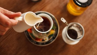 Pouring milk into a cup of tea