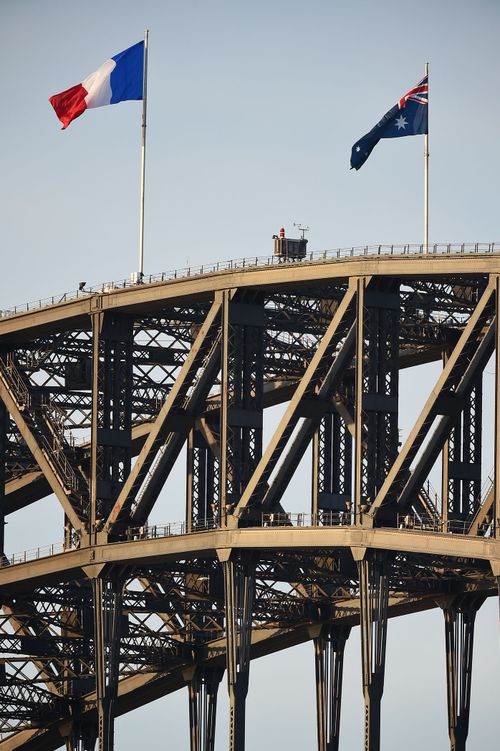 The French flag flies beside the Australian on the Sydney Harbour Bridge as a sign of solidarity after the Nice attack. (AAP)