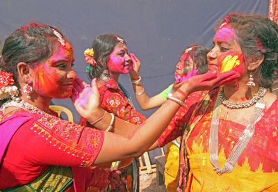 Students of Visva-Bharati University smear colour powder on each other during Basanta Utsav celebration.