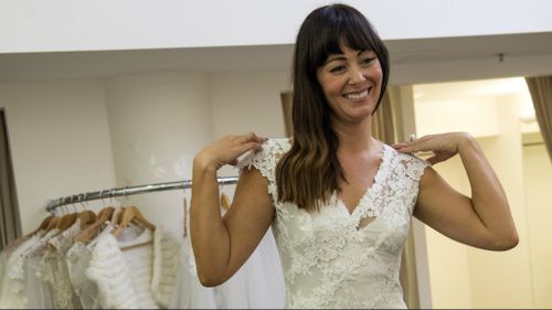 Participant Michelle tries on her wedding dress. (Nine Network)