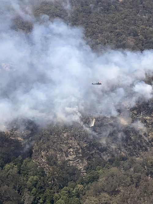 Helicopter pilots had a tricky job, ferrying people to the scene as bushfire smoke clouded vision.