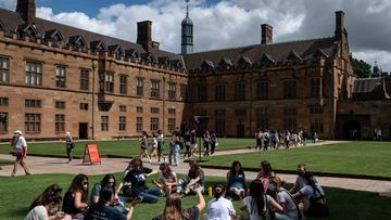 Students are seen walking through the Sydney University&#x27;s campus. 