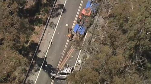 It is believed the truck driver is trapped in the cabin. (9NEWS)