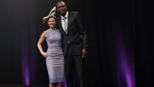 What height difference? Melbourne Cup-winning jockey Michelle Payne and Olympic champion Usain Bolt. (AAP)