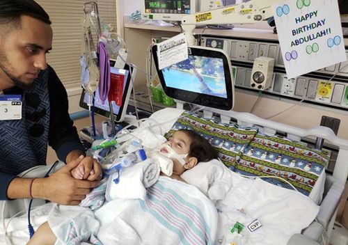 Ali Hassan with his dying 2-year-old son Abdullah in a Sacramento hospital. The boy's mother, Shaima Swileh, will catch the earliest available flight out of Egypt and is scheduled to arrive in San Francisco on Wednesday evening