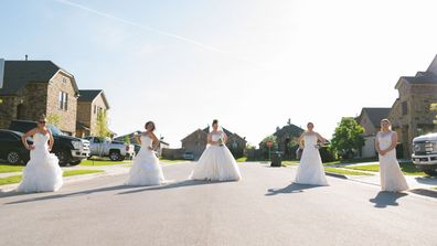 Jamie Egloff, Bryce Ellerbroek, Shannon Thomas, Nina Wagner and Jaime Sladek from Georgetown, Texas pose in their wedding dresses for fun social distancing photoshoot by neighbour Elyssa Seibel