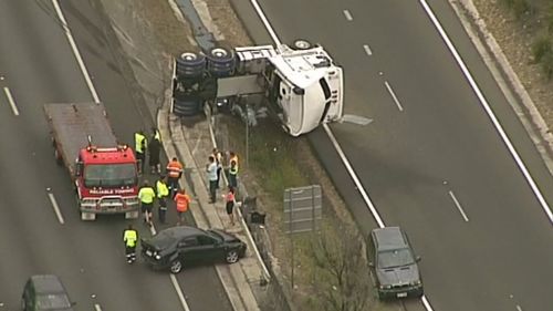 A truck has rolled and at least another two vehicles are believed to have been involved.